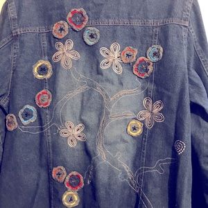 Denim jacket with floral accents.